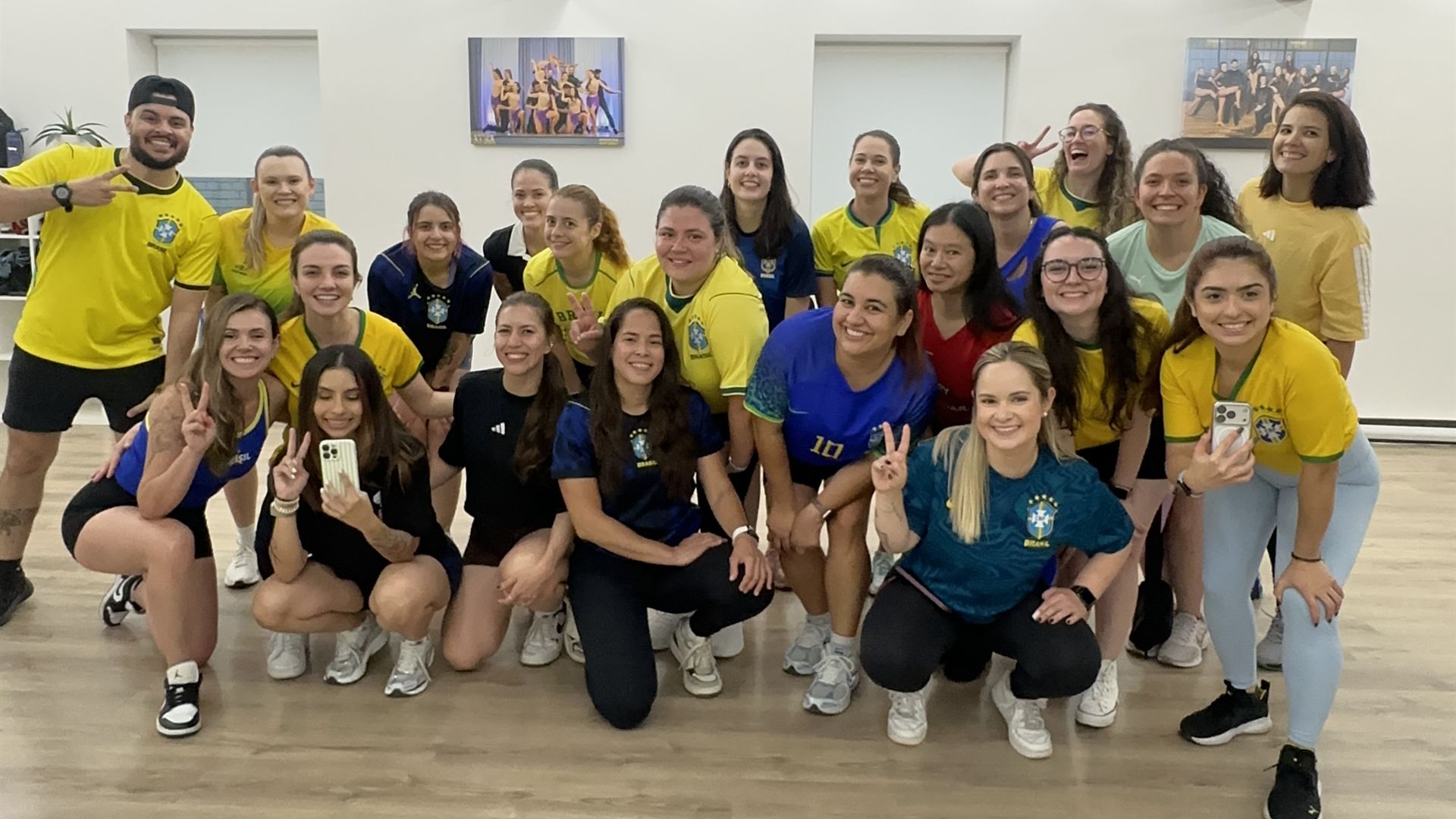 Brasileirada students in Brazil jerseys celebrating together after class